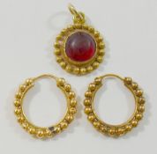 A pair of Indian yellow metal hoop earrings, unmarked, 13mm diameter,