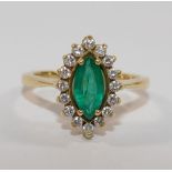 A modern 18 carat gold emerald and diamond marquise cluster ring,