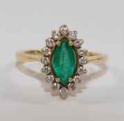 A modern 18 carat gold emerald and diamond marquise cluster ring,