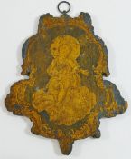 A small pine cartouche-shaped fretwork panel, depicting the Christ child painted in black and gold,