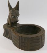 A Black Forest carved and stained Scottie dog pin tray, with glass eyes and red painted collar, 13.