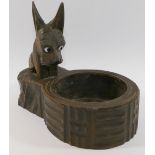 A Black Forest carved and stained Scottie dog pin tray, with glass eyes and red painted collar, 13.