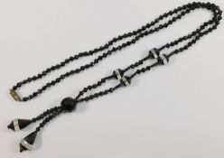 A string of 19th century black and clear paste faceted beads,