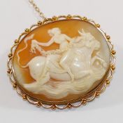 An oval carved shell cameo brooch depicting Europa riding the bull,