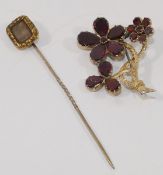 A garnet set floral spray brooch, set in yellow closed back settings, 3.