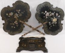 A pair of 19th century papier machè hand held face screens,