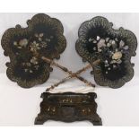 A pair of 19th century papier machè hand held face screens,