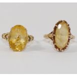 A 9 carat gold citrine set single stone ring, with open shoulders in the form of hearts,
