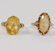 A 9 carat gold citrine set single stone ring, with open shoulders in the form of hearts,