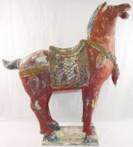 A Tang style red painted wooden horse, on rectangular plinth,