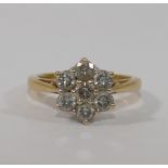 An 18 carat gold diamond daisy head cluster ring, the seven round brilliant cut stones,