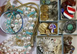 A collection of costume jewellery including a gold plated Trifari heart necklace,