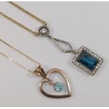 A rose coloured open heart-shaped pendant, set with a blue zircon drop, 3cm long,