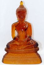 An amber glass seated Buddha,