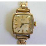 A 9 carat gold ladies Record bracelet watch, the cushion-shaped face with baton numerals, 14.