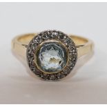 A yellow metal aquamarine and diamond circular cluster ring,