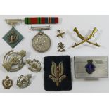 Five Royal Armoured Corps badges, an embroidered SAS badge,
