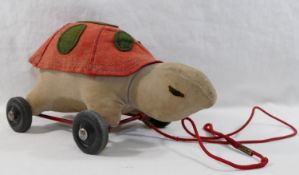 A 1950's Merrythought stuffed red and green felt and beige velvet pull along tortoise on red