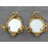 A pair of 19th century circular girandole mirrors, the twin branches each with two-lights,