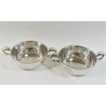 A pair of modern silver two-handled wine tasters, of plain form with scroll handles,