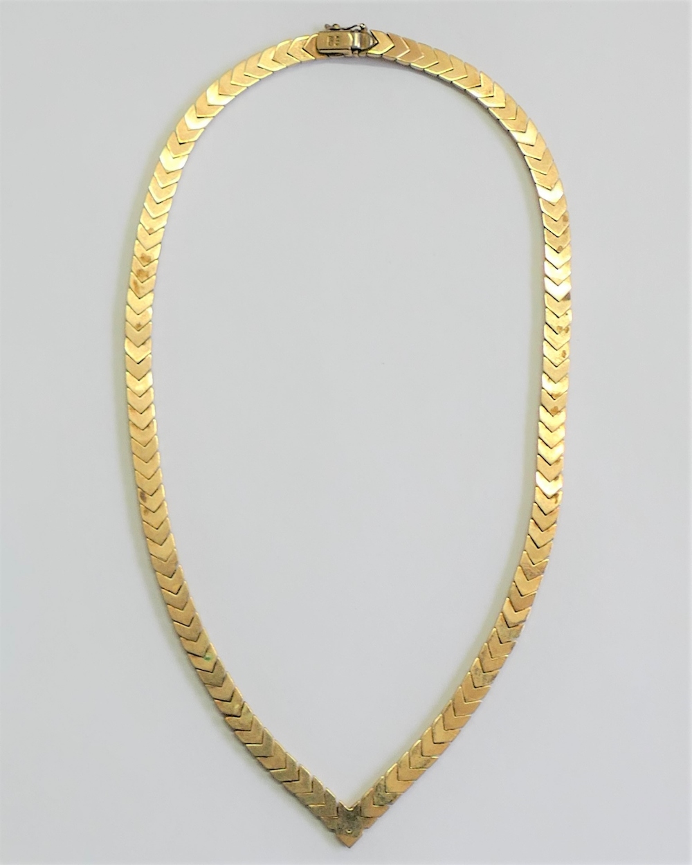 A yellow metal herringbone hollow link necklace, terminating in a point, stamped '9K', 28. - Image 2 of 2