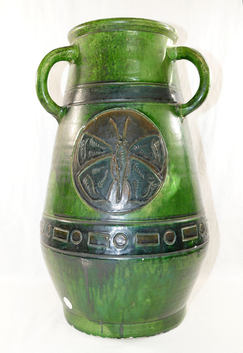 A large Studio Pottery green glazed three handled vase,