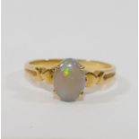 A yellow metal opal single stone ring, the shank stamped '750', finger size L, 2.