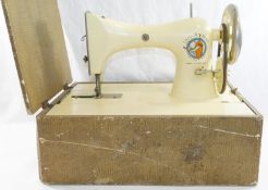 A 1930's white Tailor-Bird hand sewing machine,