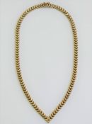 A yellow metal herringbone hollow link necklace, terminating in a point, stamped '9K', 28.