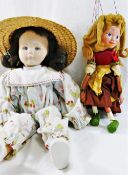 A Pelham puppet 'Gretel' 31cm long, and a cloth doll, with fabric covered moulded face,