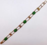 A Chinese yellow metal and jadeite bracelet stamped '14K', 10.