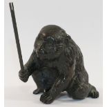 A Japanese Meiji period bronze of a macaque monkey, holding aloft a stick, signed to base of foot,