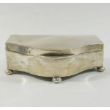 An early 20th century silver trinket box, with hinged lid, ball feet, and satin lining,