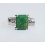 An emerald single stone ring, the emerald cut stone in four claw setting, approximately 3.