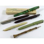 A Victorian gold plated propelling pen and pencil, the top set with agate seal, 15cm long,