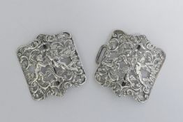An Edwardian silver nurses belt buckle, pierced and cast with cherubs,