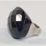 A silver and blue goldstone set dress ring, the oval stone with diamond facets, London 2007,
