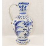 A Japanese Arita blue and white porcelain ewer, with pinched spout and scroll handle, 20cm high,