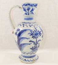 A Japanese Arita blue and white porcelain ewer, with pinched spout and scroll handle, 20cm high,