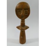 An Ashanti carved wooden female fertility figure, 16.