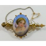 A Victorian gold bar brooch, set with oval hand painted porcelain plaque decorated with a cherub,