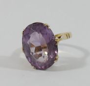 An amethyst single stone ring, the oval mixed cut stone 17mm x 13mm,