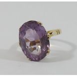 An amethyst single stone ring, the oval mixed cut stone 17mm x 13mm,