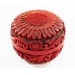 A small Cinnabar red lacquer circular box, the top carved with a flower head,