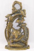 A 20th century brass door stop, cast with a fox mask and hunting regaila within a scroll surround,