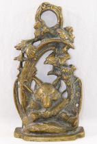 A 20th century brass door stop, cast with a fox mask and hunting regaila within a scroll surround,