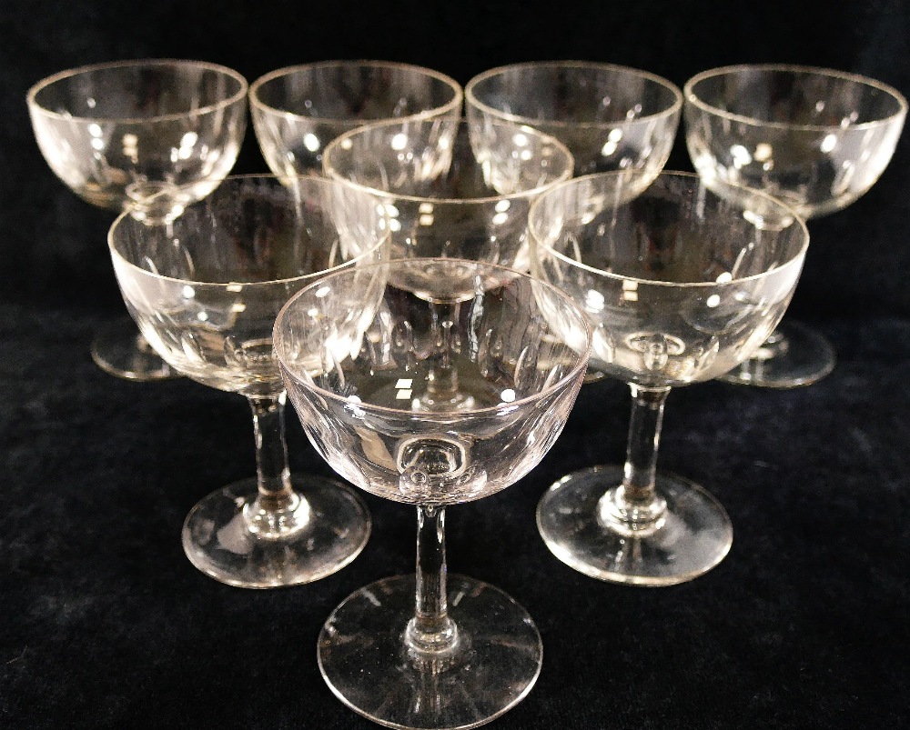 A set of eight champagne bowls, each cut with a band of seventeen small oval panels around the bowl,