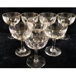 A set of eight champagne bowls, each cut with a band of seventeen small oval panels around the bowl,