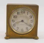 A Zenith gold plated travel clock, the body with engine turned decoration,