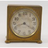 A Zenith gold plated travel clock, the body with engine turned decoration,